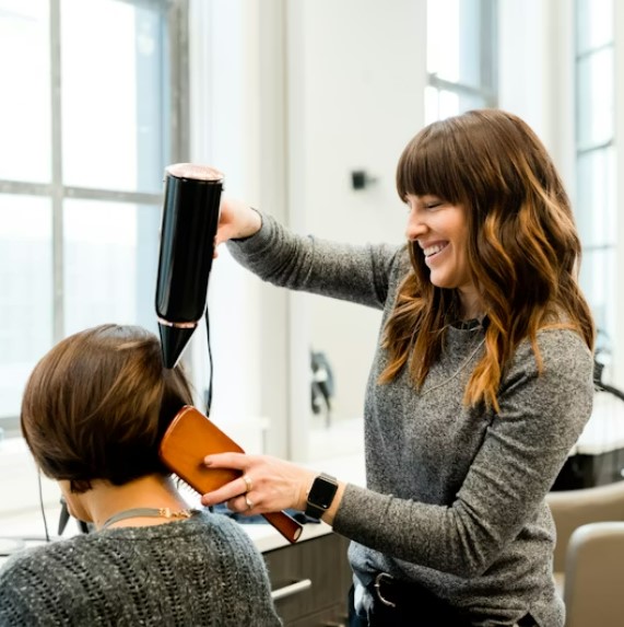 Close-up of nail extension filing process at Velvet Nail Bar